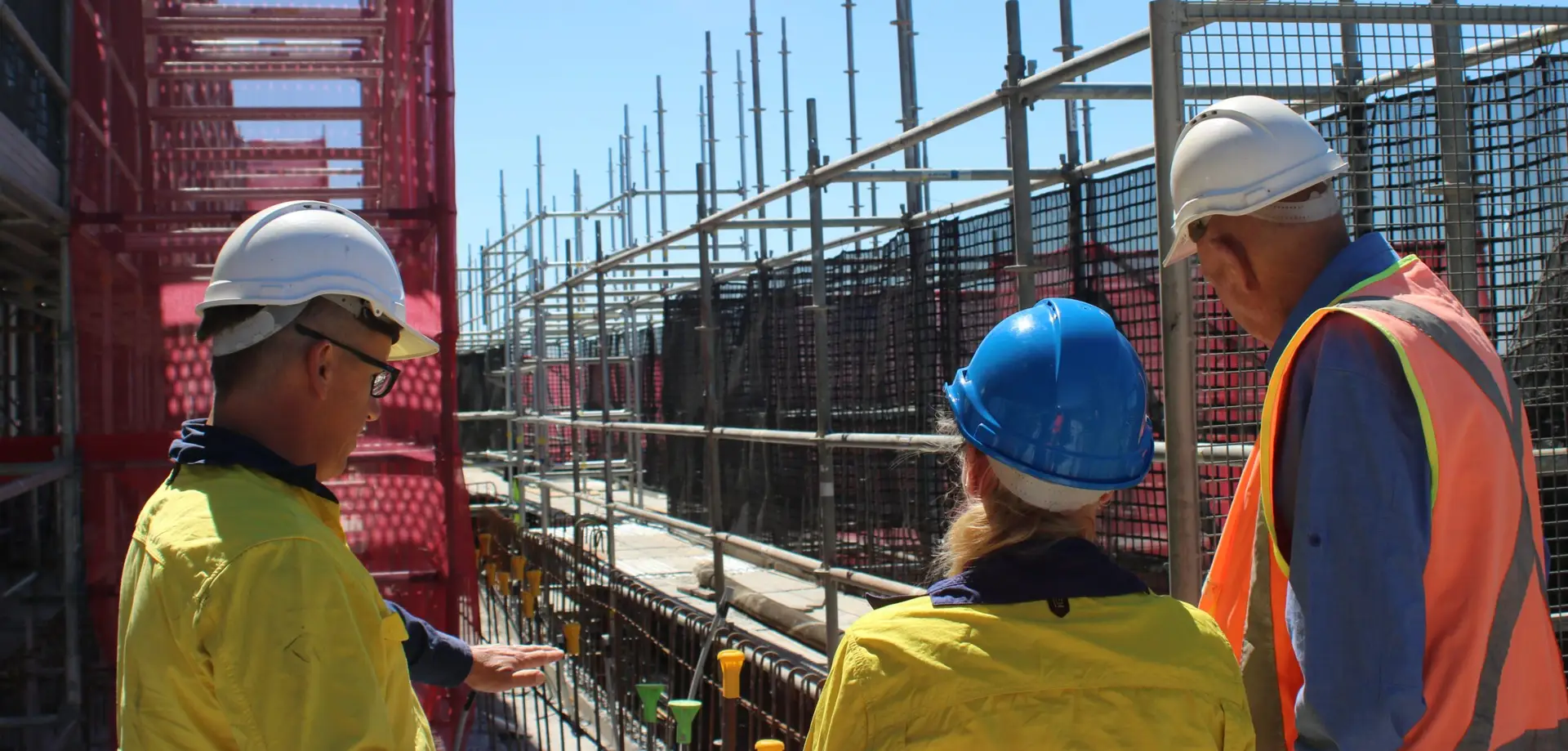 Construction workers conducting a workplace safety inspection on a commercial building site
